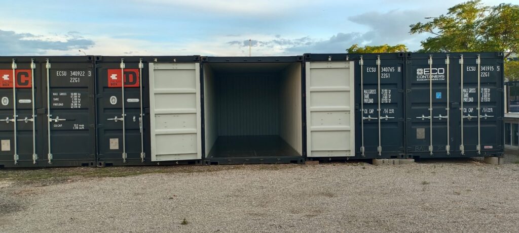 Row of 20ft containers at PalmaBox with one unit standing open